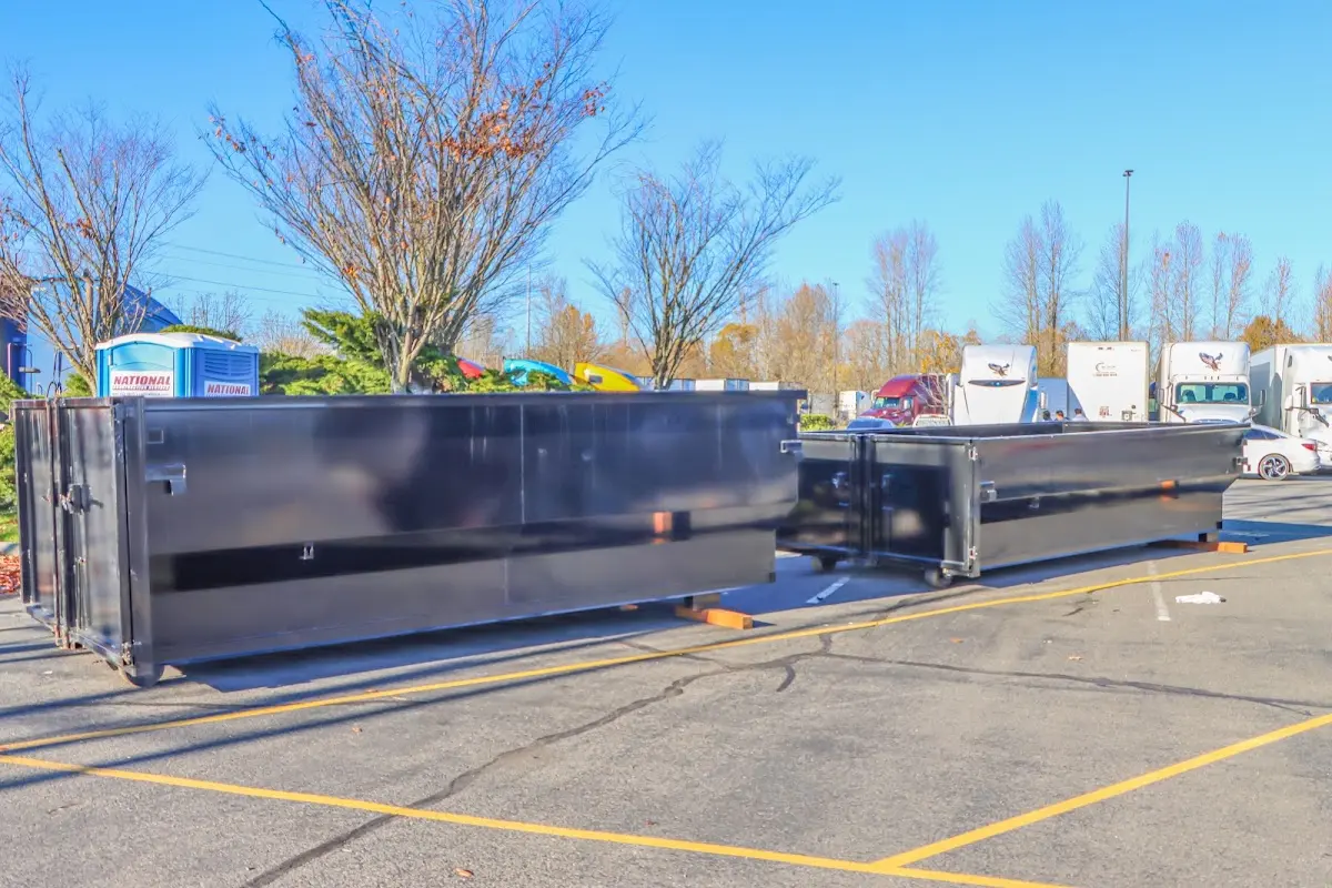 Professional dumpster rental service with roll-off container on residential driveway in Yuba City